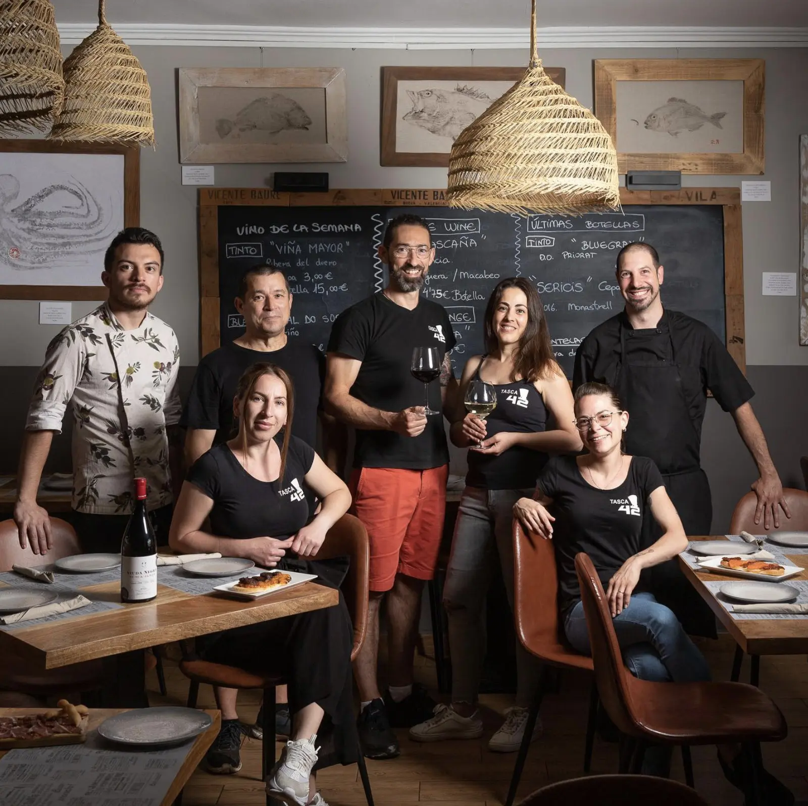 Dining room with the TASCA 42 team gathered by the menu board