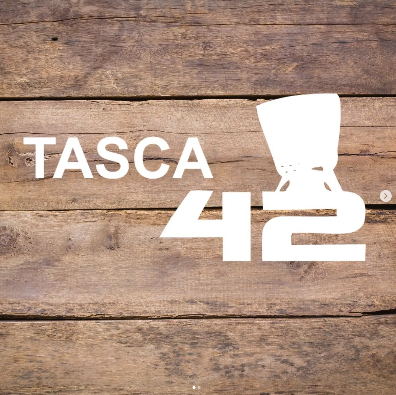 TASCA 42 name and logo displayed on a rustic wooden background