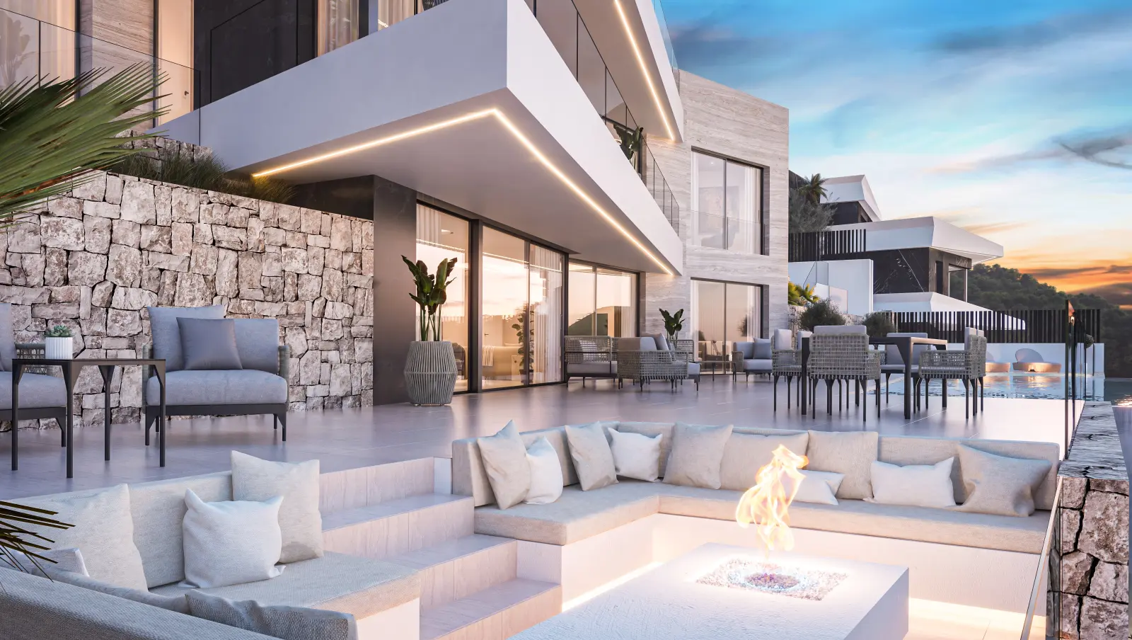 Sunken terrace lounge with a built-in fire pit beside the villa
